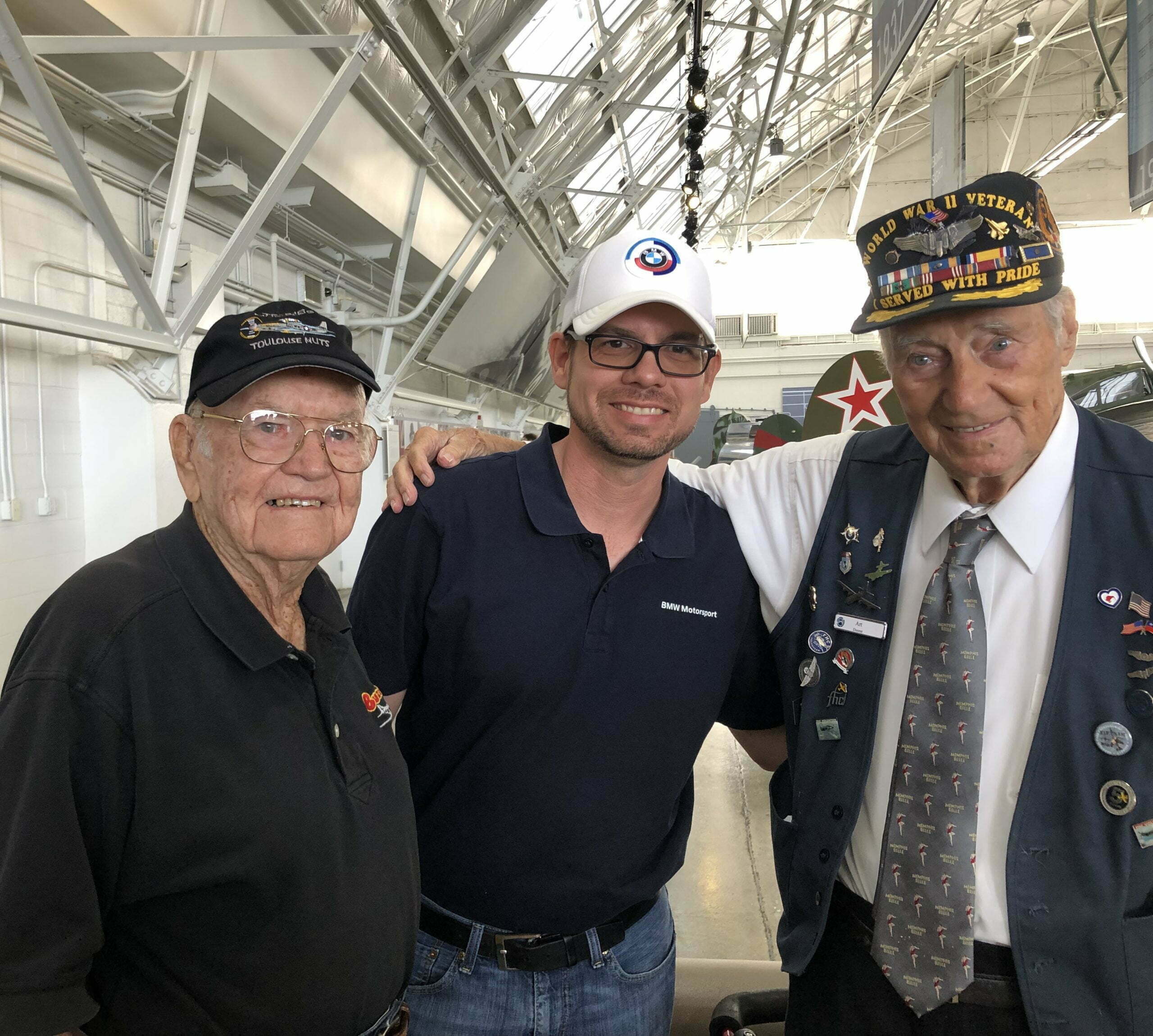 Owner standing with veterans